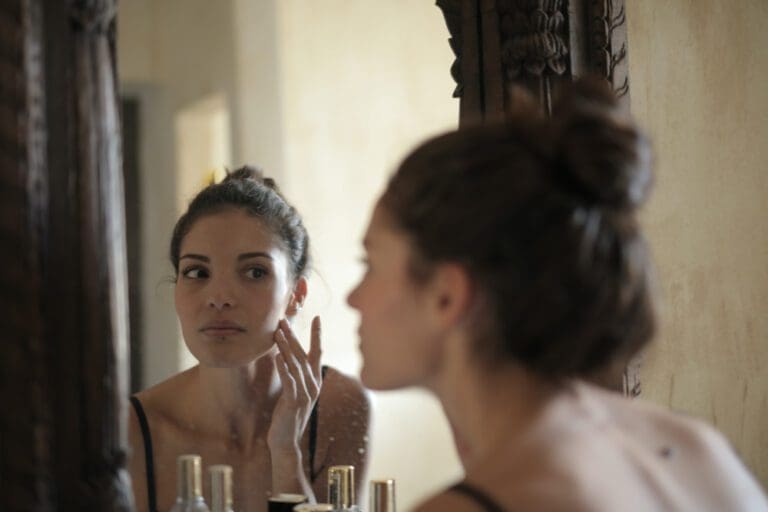 woman looking at mirror