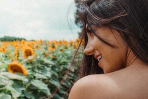 woman by field of flowers